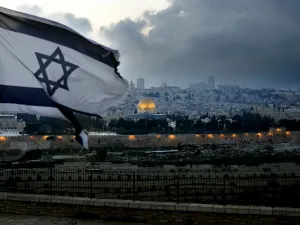 An Israeli flag flutters at Mount of Olives with the Old City of Jerusalem and its Dome of the Rock mosque in the centre, March 27, 2019. (THOMAS COEX / AFP)
