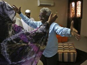 Osman Mirghani (R), editor-in-chief of independent daily Al-Tayar, is greeted by his sister following his release from jail at his home in the Sudanese capital Khartoum's twin city of Omdurman, on March 29, 2019. (AFP)