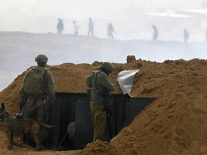 Israeli soldiers gather at a position over an earth barrier along the border with the Gaza Strip (AFP) Israeli soldiers gather at a position over an earth barrier along the border with the Gaza Strip (AFP)