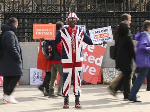 A pro-Brexit campaigner displays placards in Westminster, central London on April 3, 2019. (ISABEL INFANTES / AFP)