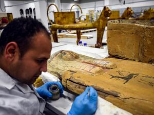 A restorer works on a sarcophagus part of the Tutankhamun collection at the restoration lab of the newly-built Grand Egyptian Museum (GEM) in Giza on the southwestern outskirts of the capital Cairo on April 7, 2019. 
(Mohamed el-Shahed / AFP)