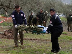 Members of the Palestinian Red Crescent carry the body of a Palestinian man who tried to stab an Israeli soldier before being shot dead, at the Bitot Junction south of Nablus in the northern occupied West Bank,on February 21, 2016. (AFP/Jaafar Ishtiyeh)