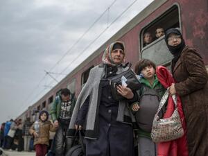 Migrants and refugees board a train after crossing the Greek-Macedonian border near Gevgelija on February 24, 2016. (AFP/Robert Atanasovski)