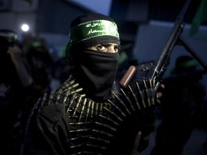 A member of the Ezzedine al-Qassam Brigades, the military wing of the Palestinian Islamist movement Hamas holds his weapon during a rally to mark the 12th anniversary of the death of assassinated Hamas spiritual leader Sheikh Ahmed Yassine on March 23, 2016 outside his home in Gaza city. (AFP/Mahmud Hams)
