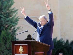 President Michel Aoun in jubilation, raising the signs of victory as Lebanon firmly sets on the road to parliamentary elections, the first since 2009. (AFP/File Photo)