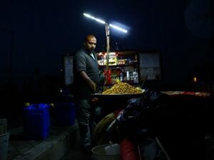 A street vendor during a power cut in Gaza (AFP/File)