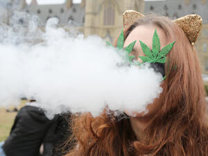 A woman smokes marijuana on Parliament Hill on 4/20 in Ottawa, Ontario, April 20, 2017. (AFP/Lars Harberg)