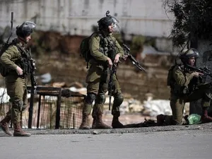 Israeli security forces stand in the street during clashes with Palestinian demonstrators in the West Bank city of Hebron. (AFP/File)