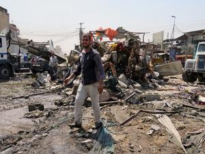 A man stands at the site of the deadly bomb blast which killed 11. (AFP)