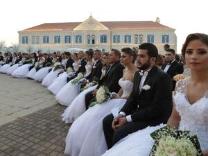 Lebanese Maronite Christian couples take part in a mass wedding at the Maronite Patriarchate in Bkerke on September 3, 2017. Twenty-six couples got married during the event organised by the Maronite league. (AFP)