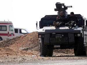 Members of Egyptian security forces resting on top of an armoured vehicle ( AFP)
