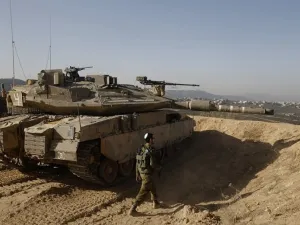 Israeli soldier walking next to a tank. (AFP/ File)