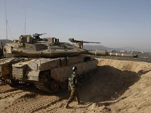 Israeli soldier walking next to a tank. (AFP/ File)