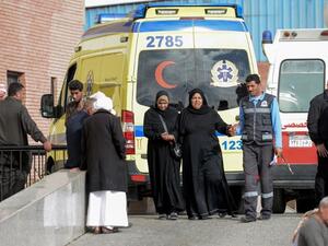 Relatives of the victims of the bomb and gun assault on the North Sinai Rawda mosque walk past an ambulance while waiting outside the Suez Canal University hospital. (AFP)
