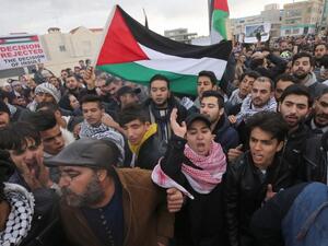 Protesters shout slogans and wave the Jordanian flag during a demonstration near the American Embassy in Amman against U.S. President Donald Trump's decision to recognise Jerusalem as the capital of Israel. (KHALIL MAZRAAWI / AFP)