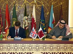 Qatar's Defense Minister Khalid bin Mohammed al-Attiyah (R) signs an agreement with his British counterpart Gavin Williamson to buy 24 Typhoon fighters from the U.K., in the capital Doha on Dec. 10, 2017 (Stringer/AFP)
