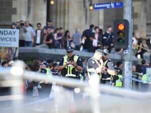 Police and emergency personnel work at the scene of where a car ran over pedestrians in Flinders Street in Melbourne on Dec. 21, 2017 (Mal Fairclough / AFP)