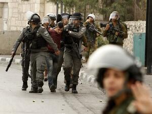 Israeli security forces detain a Palestinian protester during clashes at the main entrance of the Israeli occupied West Bank city of Bethlehem on Dec. 22, 2017 (Musa AL SHAER / AFP)