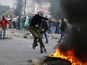 A Palestinian protester throws a stone during clashes with Israeli forces near the Huwara checkpoint south of Nablus in the Israeli-occupied West Bank as protests continue in the region.
(Jaafar ASHTIYEH / AFP)
