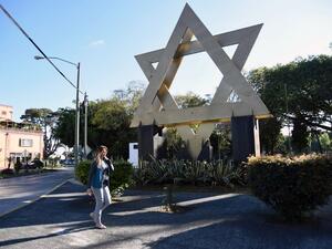 A woman walks across Israel square in Guatemala City (AFP/File Photo)