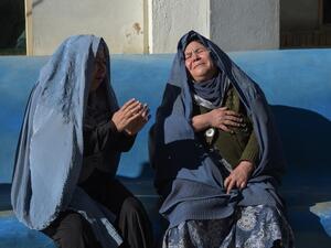 Two Afghan women weep for their relatives at a hospital following explosions at a Shiite cultural centre in Kabul on Dec. 28, 2017. (AFP/ SHAH MARAI)