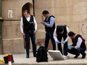 Egyptian security members and forensic police inspect the site of a gun attack outside a church south of the capital Cairo, on Dec. 29, 2017. A gunman opened fire on a church, killing at least nine people before policemen shot him dead, state media and officials said. 
(STRINGER / AFP)
