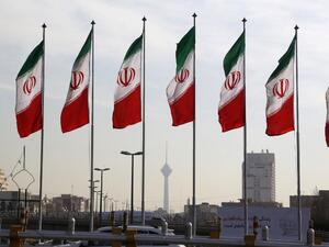 Tehran's landmark Milad Tower (C) is seen through a row of national flags in the center of the Iranian capital on Jan. 3, 2018 (ATTA KENARE/AFP)