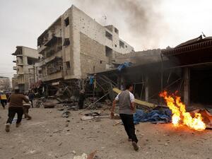Civilians and members of the Syrian Civil Defence, known as the White Helmets, run at the scene of a reported air strike on the city of Maaret al-Numan in Syria's rebel-held Idlib province on Jan. 3, 2018 (OMAR HAJ KADOUR/AFP)