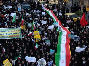 Iranian pro-government supporters march during the funeral of a young member of the Revolutionary Guards, Sajjad Shahsanai, in the city of Najafabad, west of Isfahan, on Jan. 3, 2018 (Morteza SALEHI/TASNIM NEWS/AFP)