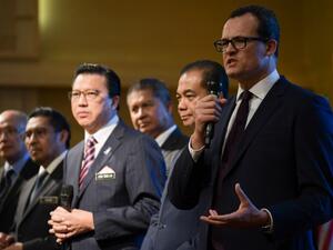 CEO of Ocean Infinity Limited Oliver Plunkett (R) speaks during a press conference after a signing ceremony to resume the search for missing Malaysia Airlines flight MH370 at the Malaysian federal administrative center in Putrajaya, outside Kuala Lumpur on Jan. 10, 2018 (MOHD RASFAN / AFP)