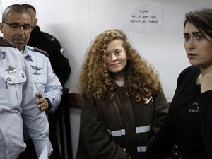 Sixteen-year-old Palestinian Ahed Tamimi (2-R), a well-known campaigner against Israel's occupation, standing for a hearing in the Israeli military court at Ofer military prison in the West Bank village of Betunia on Jan. 15, 2018 (THOMAS COEX / AFP)