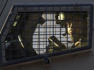 A member of the Israeli forces is seen inside a vehicle during a military operation in Jenin, in the north of the occupied West Bank, on January 18, 2018. A Palestinian was killed during clashes with Israeli forces in Jenin, the Palestinian health ministry announced. Israel's Shin Beth security services said shots were fired during a raid by border guards to capture the alleged perpetrators of an attack earlier this month in which a rabbi was shot dead. 
(JAAFAR ASHTIYEH / AFP)