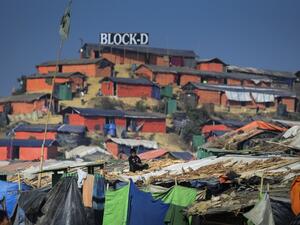 A Rohingya refugee child sits with drying wood for cooking on his roof at Thankhali refugee camp in Bangladesh's Ukhia district on Jan. 22, 2018 (Munir UZ ZAMAN / AFP)