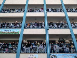 Palestinian schoolgirls pose for a group picture outside their classrooms at a school belonging to the United Nations Relief and Works Agency for Palestine Refugees (UNRWA) in Gaza City on Jan. 22, 2018 (MAHMUD HAMS / AFP)