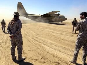 Saudi soldiers stand by as a Saudi Air Force cargo plane carrying humanitarian aid lands at an airfield in Yemen's northeastern province of Marib. (ABDULLAH AL-QADRY / AFP)