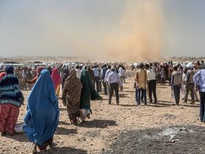 People gather prior to a food distribution at the Internally displaced person camp (IDP) of Farburo in Gode, near Kebri Dahar, southeastern Ethiopia, on Jan. 27, 2018. The camp recently hosted Somali families fleeing conflict between Somali and Oromo communities in Ethiopia (YONAS TADESSE / AFP)