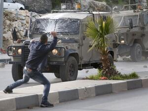 Palestinians throw stones at Israeli army vehicles after forces entered the village of Halhoul in the occupied West Bank on Feb. 07, 2018. A Palestinian stabbed a security guard at the entrance to an Israeli settlement and was shot dead in the latest violence in the occupied West Bank, Israel's military said.
(HAZEM BADER / AFP) Palestinians throw stones at Israeli army vehicles after forces entered the village of Halhoul in the occupied West Bank on Feb. 07, 2018. A Palestinian stabbed a security guard at the entrance to an Israeli settlement and was shot dead in the latest violence in the occupied West Bank, Israel's military said.
(HAZEM BADER / AFP)