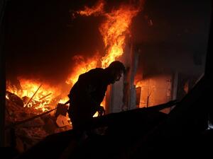 A Syrian man searches for people in a fire following regime air strikes on the rebel-held besieged town of Douma in the eastern Ghouta region, on the outskirts of the capital Damascus, on Feb. 7, 2018. 
(Hamza Al-Ajweh / AFP)