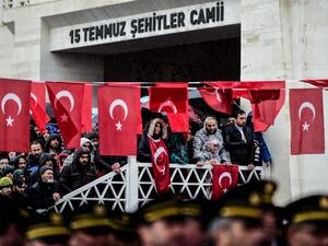 People stand by Turkish flags as they attend a funeral ceremony for Koray Karaca, a Turkish soldier who was killed in cross-border clashes with Kurdish People's Protection Units (YPG) forces in Afrin, Syria, in Istanbul on Feb. 11, 2018. On Jan. 20, Turkey launched a military operation against the Kurdish People's Protection Units (YPG) militia in the Afrin region, backing Syrian rebels with air strikes and ground troops.
(YASIN AKGUL / AFP)