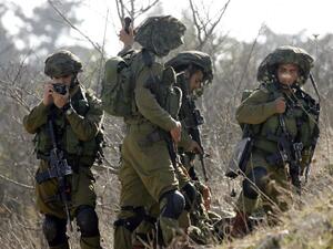  Israeli soldiers patrolling along the Israeli border (AFP/File Photo)