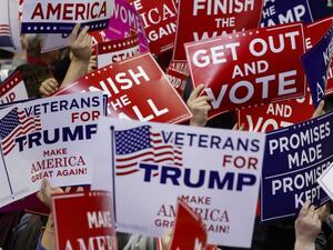 Supporters wave campaign signs during a capmpaign rally for Republican Senate candidate Mike Braun and attended by U.S. President Donald Trump. (AFP/FILE)