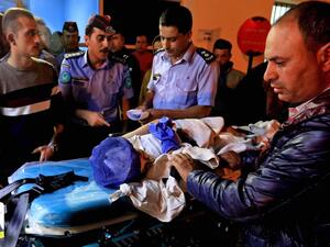 An injured pupil lays on a stretcher at a hospital in Jordan. ( AFP/ File)