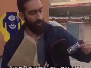 The woman filmed herself arguing with the man about the country's strict regime before he pulled a black bottle from his bag (right) and sprayed it in her face (Twitter)