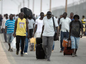 African migrants carry their belongings at a detention center in Israel's Negev desert (AFP/File Photo)