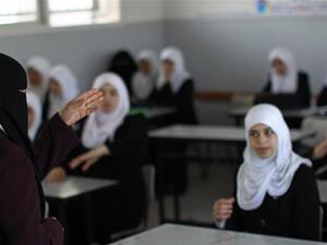 A Palestinian teacher instructs female students in a classroom in Gaza City on April 2, 201. (AFP/File)