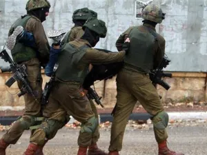 Israeli soldiers manhandles a Palestinian after he was detained during clashes in the West Bank city of Bethlehem. (AFP/FILE)