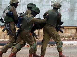 Israeli soldiers manhandles a Palestinian after he was detained during clashes in the West Bank city of Bethlehem. (AFP/FILE)