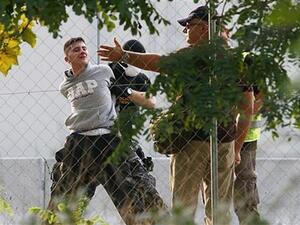 Hungarian police arrest a refugee on the border during clashes last year. (AFP/File)