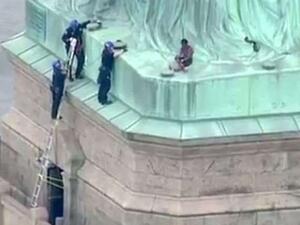Police were seen talking to Okoumou in an effort to get her down, but she refused to cooperate (AFP/File Photo)