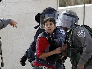 Israeli soldiers detain a Palestinian youth during protests in the West Bank. (AFP/File)